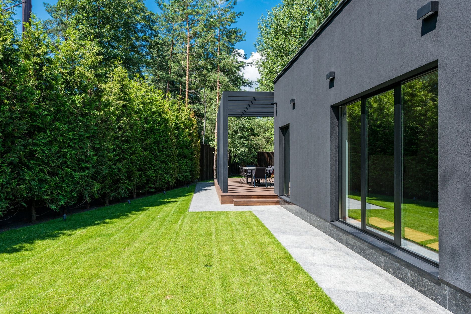Freshly striped lawn beside a clipped hedge